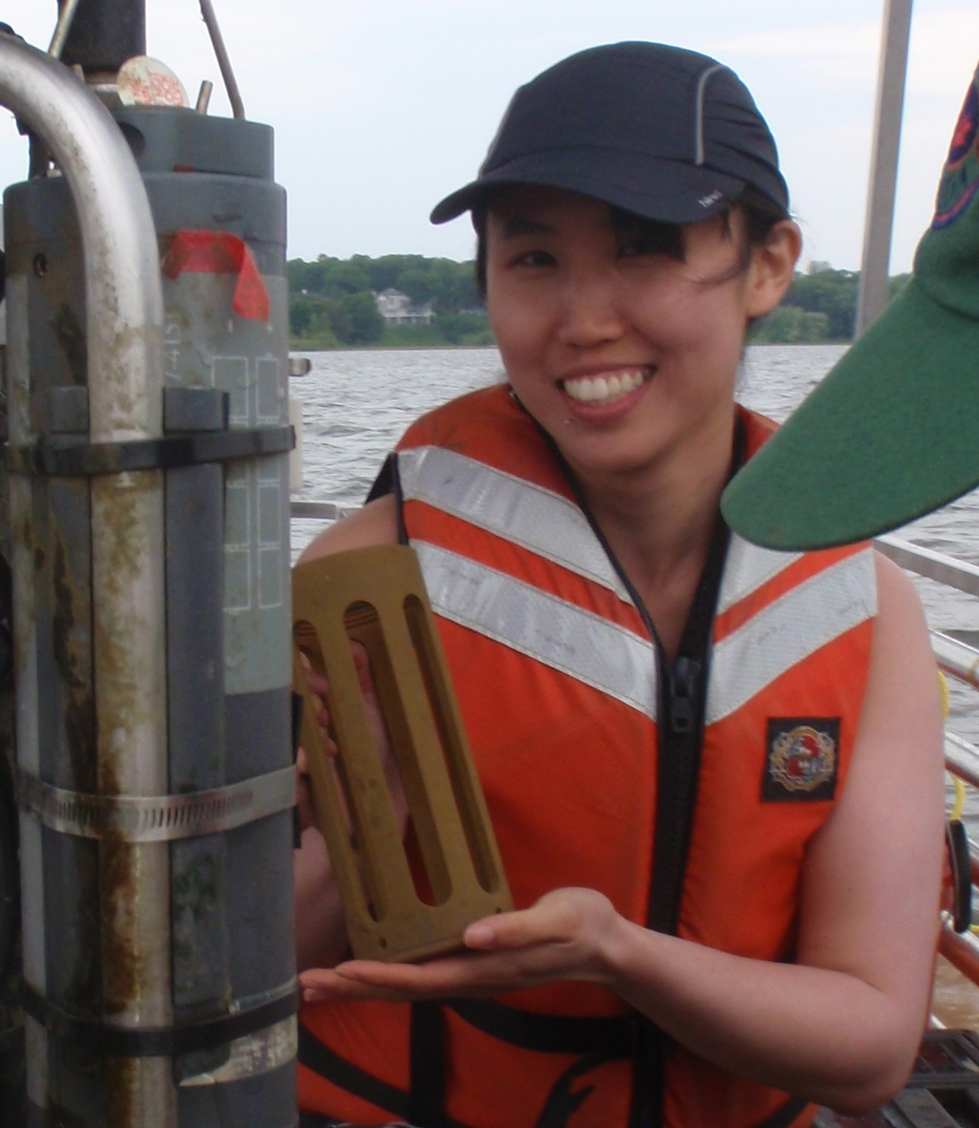 Vingie Ng holds a sonde cage next to subsurface sensors